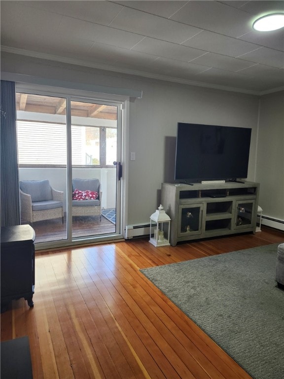 living area featuring a baseboard radiator, crown molding, and wood finished floors