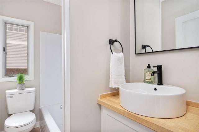 bathroom featuring toilet and vanity