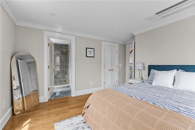 bedroom with baseboards, light wood finished floors, visible vents, and crown molding