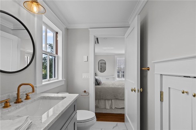 bathroom with ensuite bathroom, toilet, vanity, baseboards, and ornamental molding