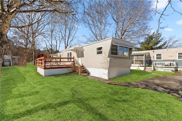 exterior space featuring a deck and a lawn