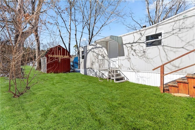 view of yard featuring an outbuilding, entry steps, and a storage unit