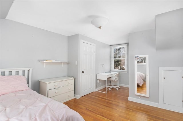 bedroom with light wood-style flooring and baseboards