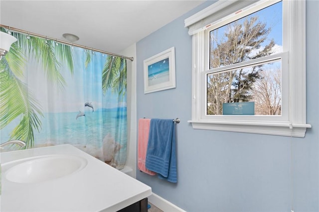 full bathroom featuring curtained shower and a sink