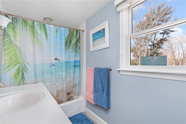 full bathroom featuring a sink and shower / tub combo with curtain