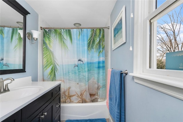 bathroom featuring a wealth of natural light, vanity, and shower / tub combo