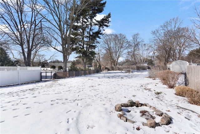 snowy yard with fence