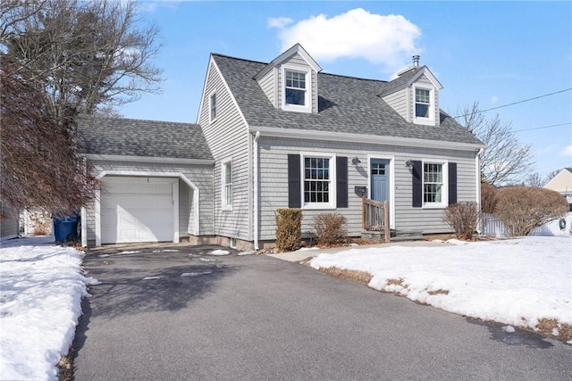 cape cod house featuring entry steps, driveway, roof with shingles, and an attached garage