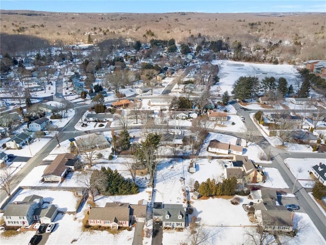 snowy aerial view with a residential view