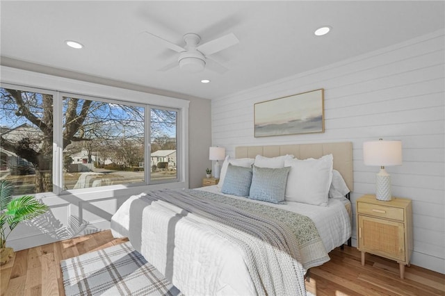 bedroom with ceiling fan, wood finished floors, and recessed lighting