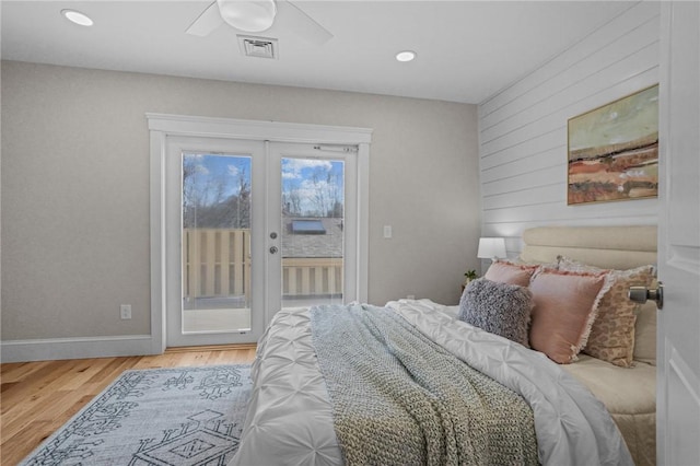 bedroom featuring french doors, visible vents, wood finished floors, access to outside, and baseboards