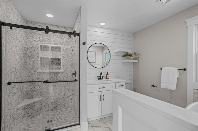 full bathroom with marble finish floor, a shower stall, vanity, and recessed lighting