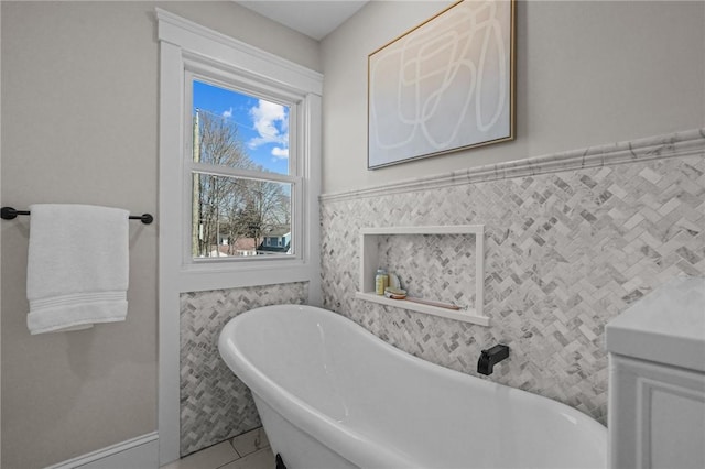 bathroom featuring a freestanding tub and tile walls