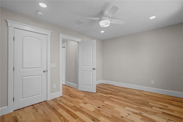 unfurnished bedroom with recessed lighting, light wood-style flooring, and baseboards