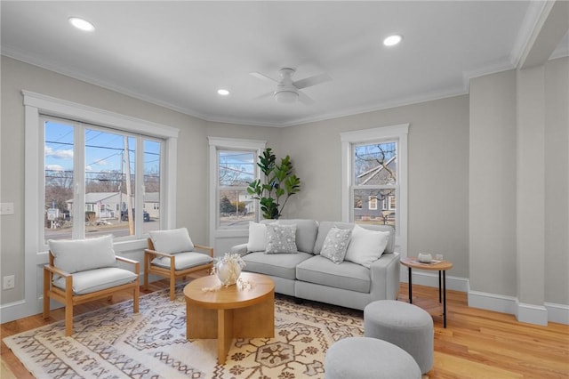 living area featuring light wood-type flooring, recessed lighting, baseboards, and ornamental molding