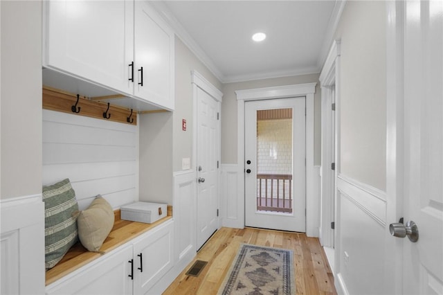 mudroom with a decorative wall, visible vents, ornamental molding, wainscoting, and light wood finished floors