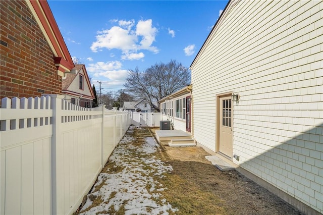 view of yard featuring a fenced backyard and central AC unit