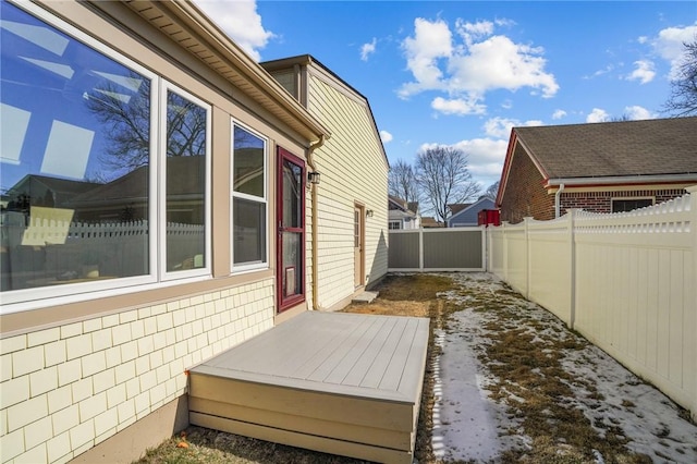 view of side of property featuring a fenced backyard and a deck