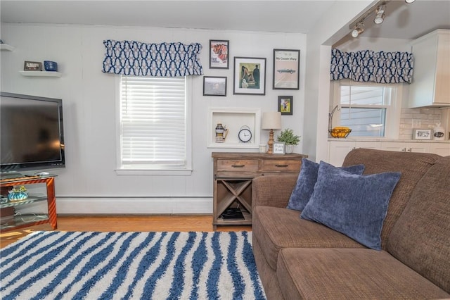 living area featuring light wood finished floors and a baseboard heating unit