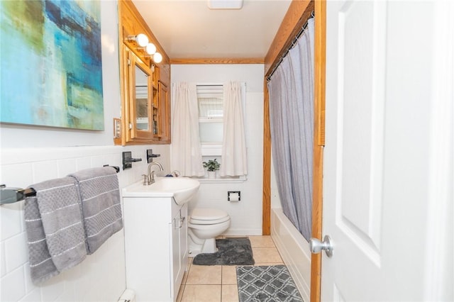 full bath with toilet, shower / tub combo, tile walls, vanity, and tile patterned floors