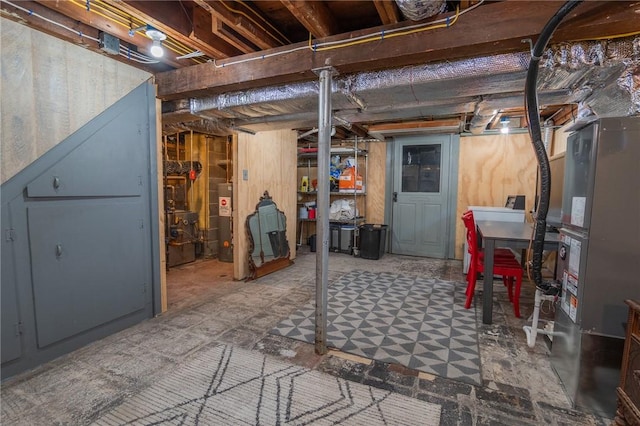 unfinished basement with heating unit, water heater, and tile patterned floors