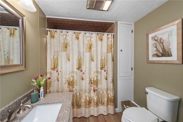 full bath featuring curtained shower, a textured ceiling, toilet, and wood finished floors