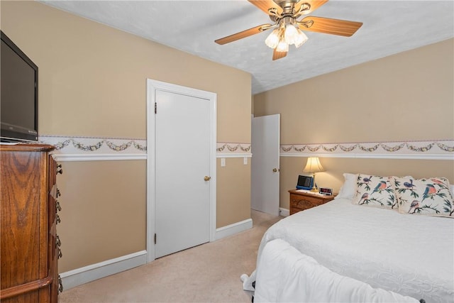 bedroom with light colored carpet and ceiling fan