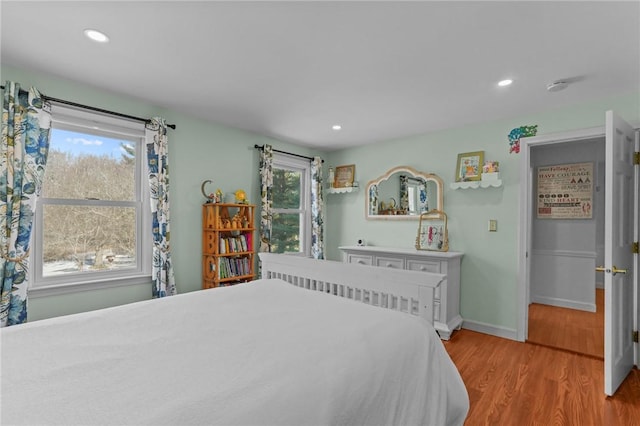 bedroom with light wood-style floors, baseboards, and recessed lighting