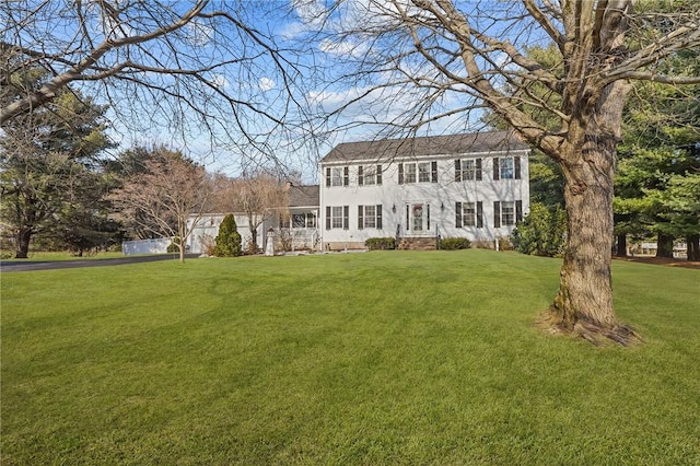 colonial inspired home with a front yard