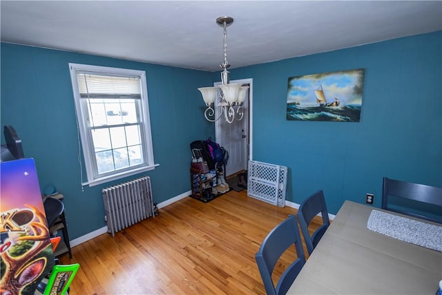 office with radiator heating unit, baseboards, and wood finished floors