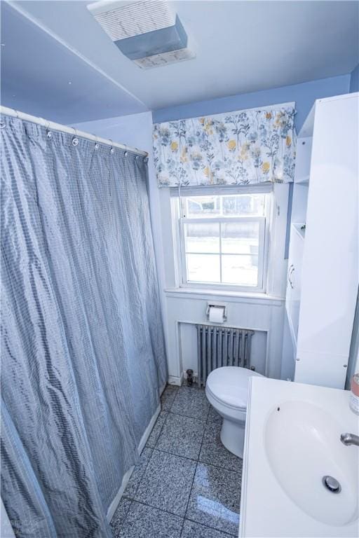 bathroom with visible vents, radiator, toilet, granite finish floor, and a sink