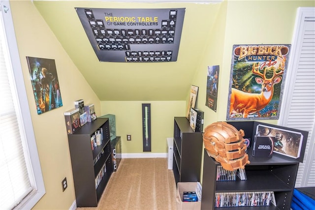 office space with light carpet, vaulted ceiling, and baseboards