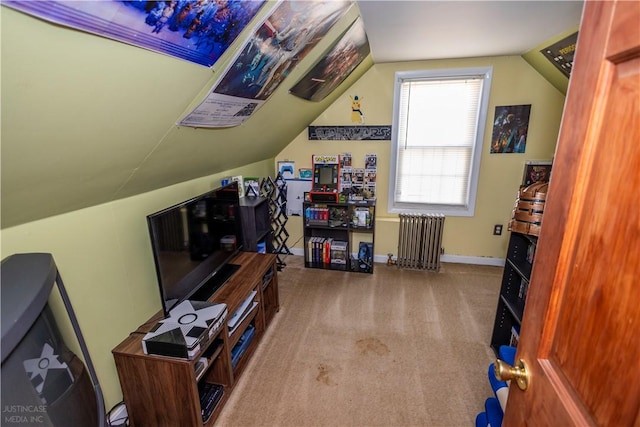 rec room with lofted ceiling, radiator heating unit, baseboards, and light colored carpet