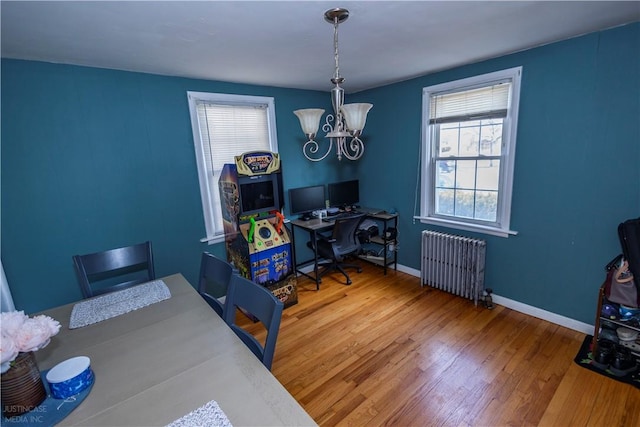 home office featuring radiator, an inviting chandelier, baseboards, and wood finished floors