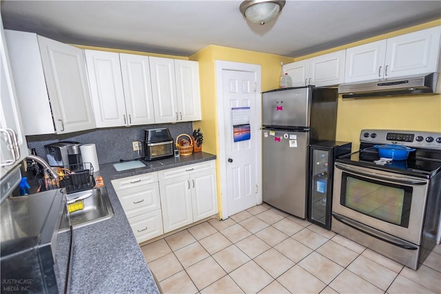 kitchen featuring appliances with stainless steel finishes, white cabinetry, and under cabinet range hood