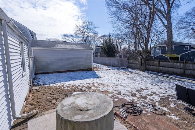 yard layered in snow with a fenced backyard