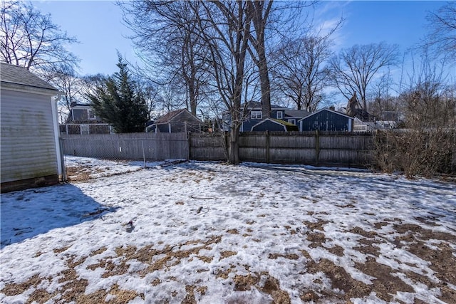 snowy yard with fence