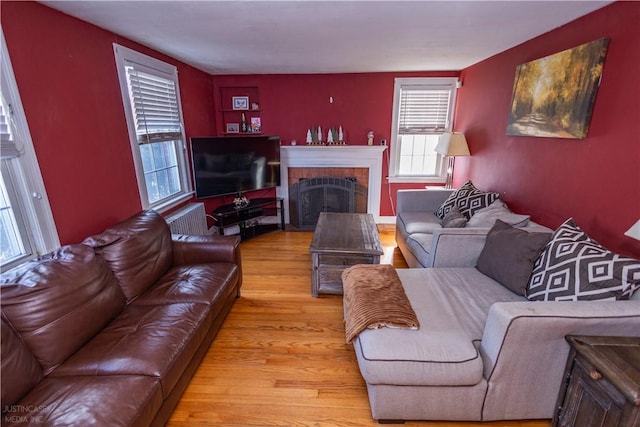 living area with light wood-type flooring and a fireplace