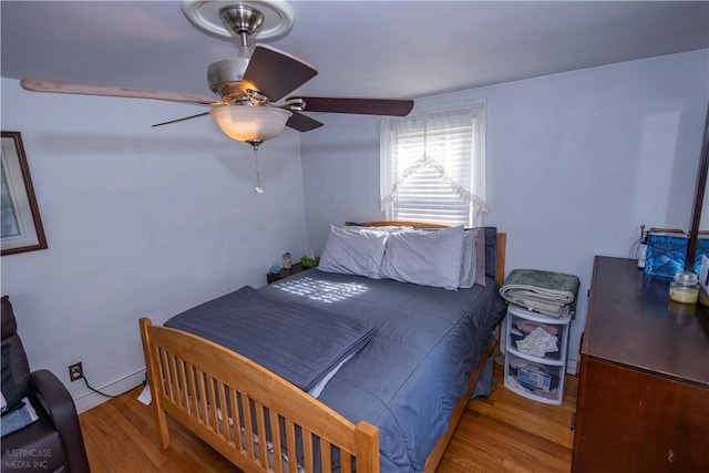 bedroom with ceiling fan and wood finished floors