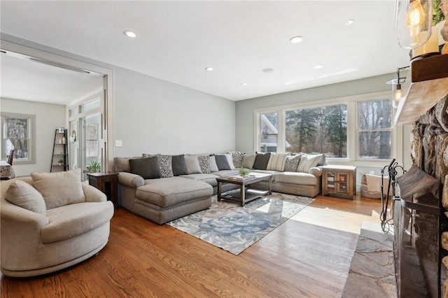 living area featuring wood finished floors and recessed lighting