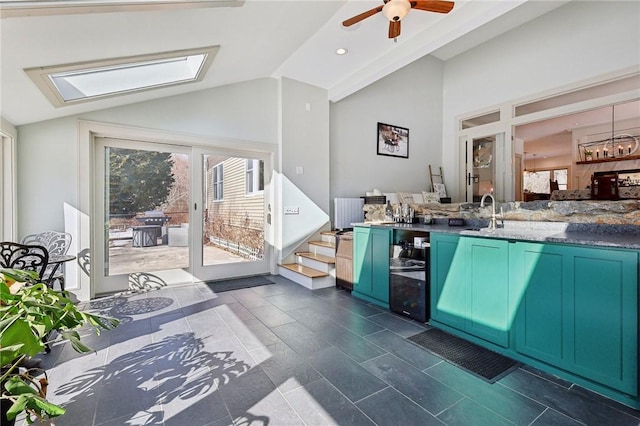 interior space with lofted ceiling, ceiling fan, stone countertops, recessed lighting, and a sink