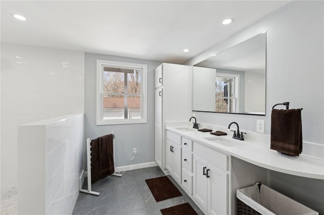 full bathroom featuring recessed lighting, a sink, and double vanity