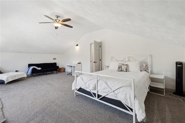 bedroom featuring carpet, vaulted ceiling, a textured ceiling, and ceiling fan