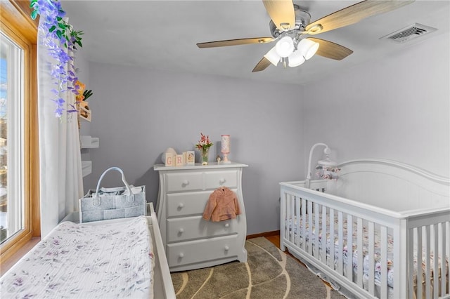 bedroom featuring ceiling fan, visible vents, and baseboards