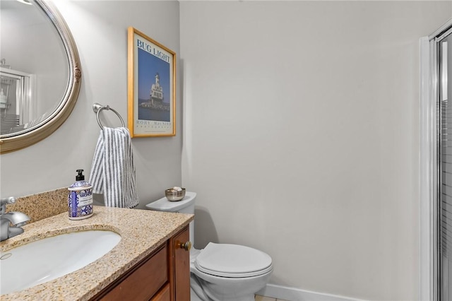 bathroom featuring toilet and vanity