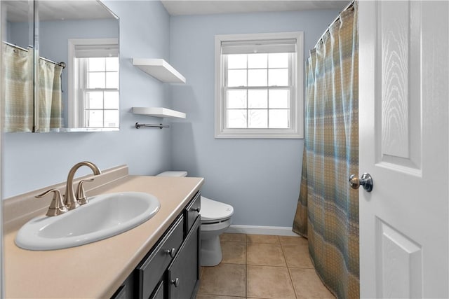 bathroom featuring baseboards, vanity, toilet, and tile patterned floors