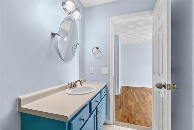 bathroom with wood finished floors and vanity