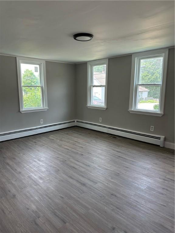 unfurnished room with wood finished floors