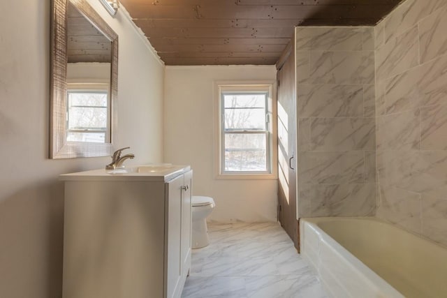 bathroom with marble finish floor, plenty of natural light, vanity, and toilet