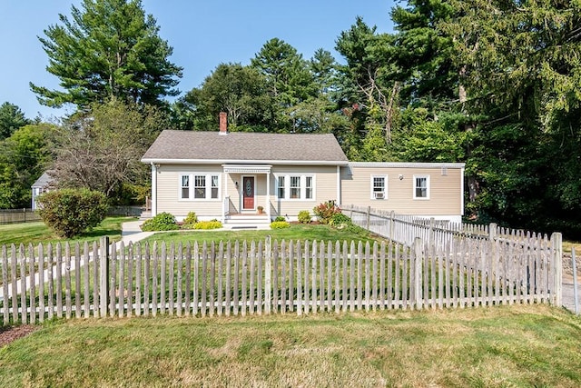 view of front of house with a fenced front yard, a front yard, and a chimney